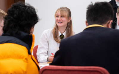 A student engaging an a discussion with other pupils